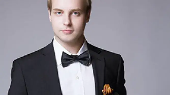 Andrii Isakov in a gray background.
