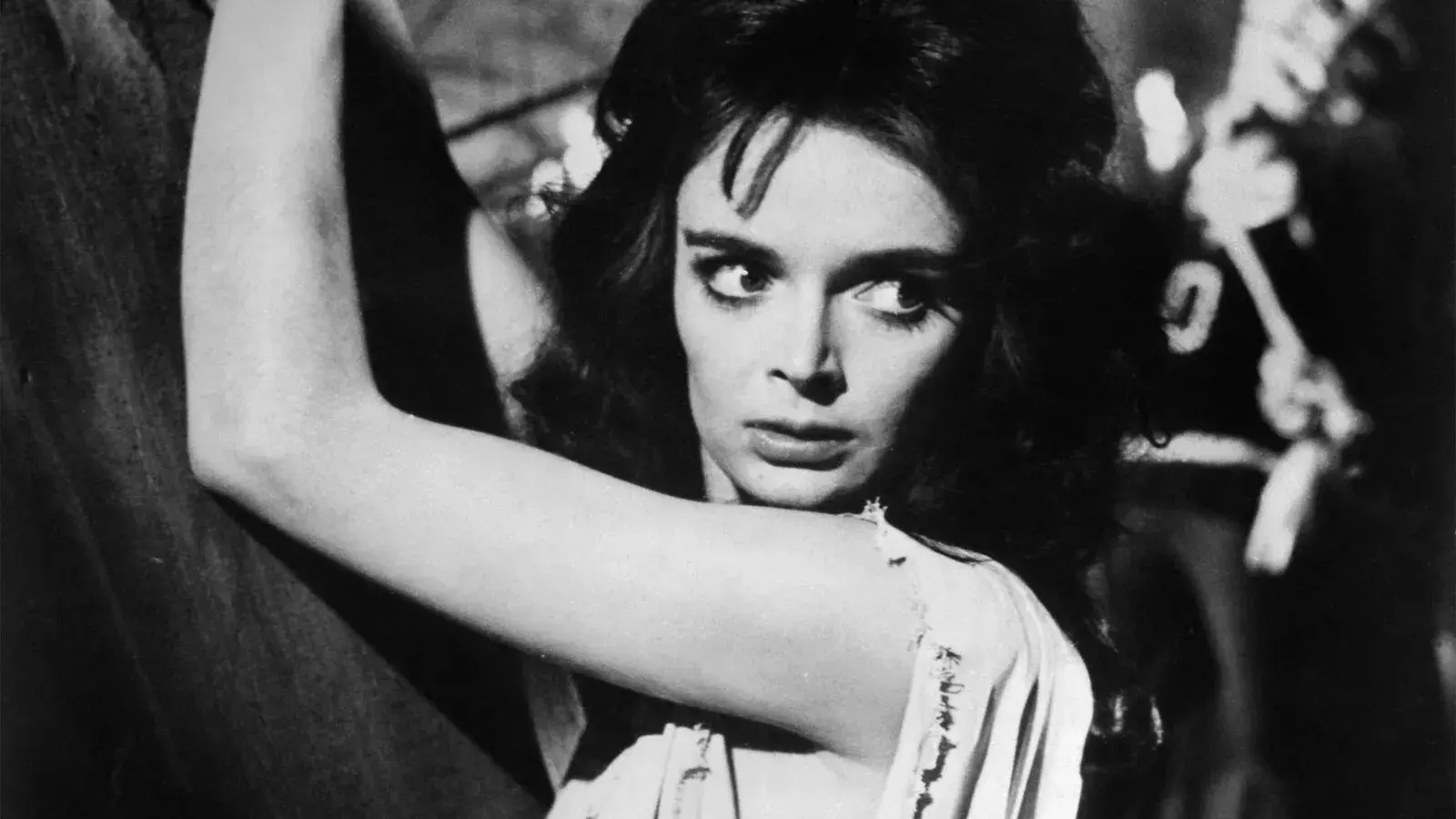 1. Black and white close-up of a woman’s face with her arms above her head.