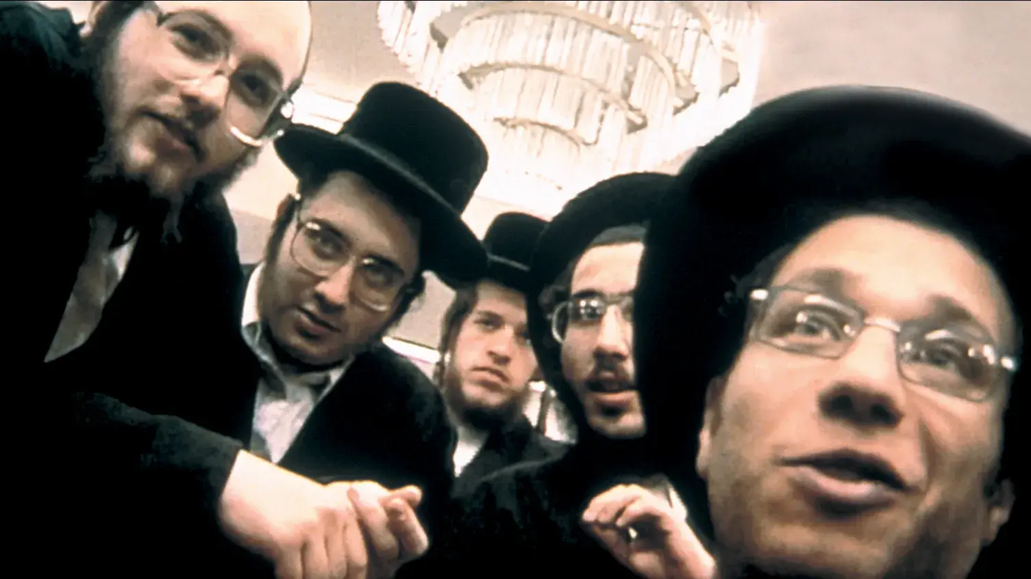 A group of Orthodox Jewish men pose for a picture.