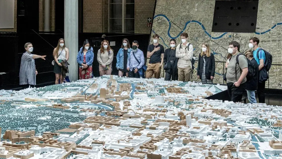 Students examine the Berlin Stadtmodelle with Dr. Vanessa Carlow, Director of SpACE Lab, at the Senate Department of Urban Development.