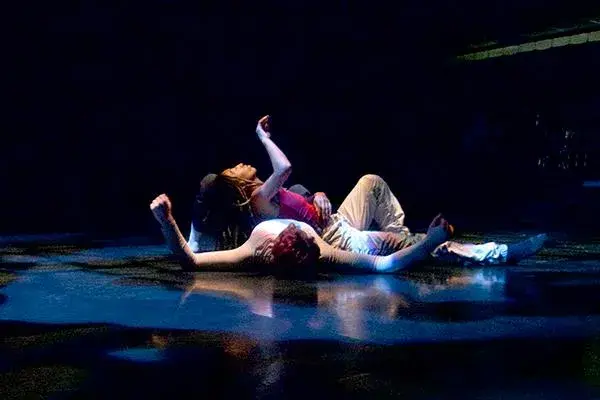 Dancers in movement on their backs on the floor