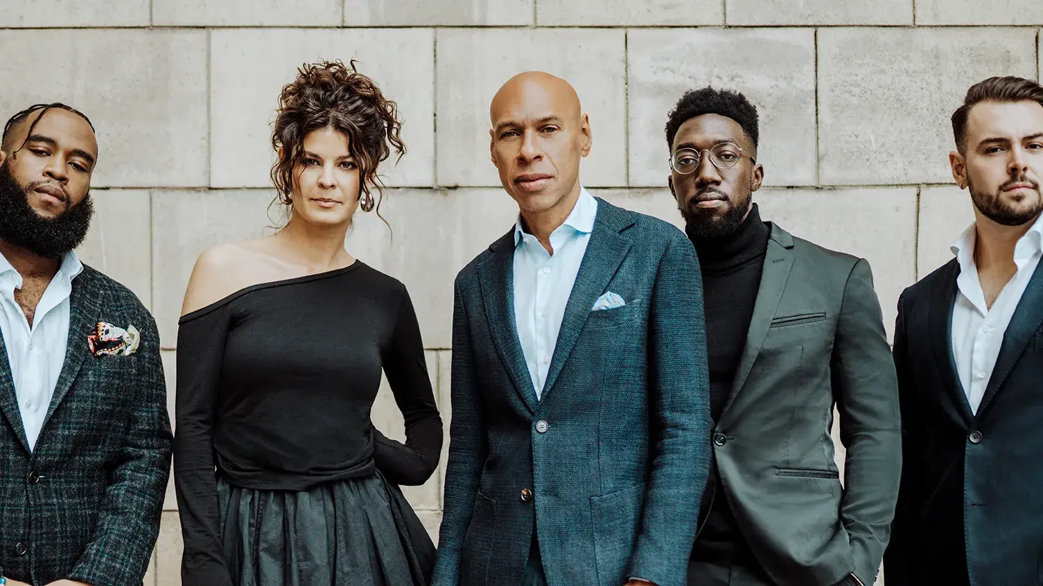 Joshua Redman Group standing with Gabrielle Cavassa in front of a stone wall.