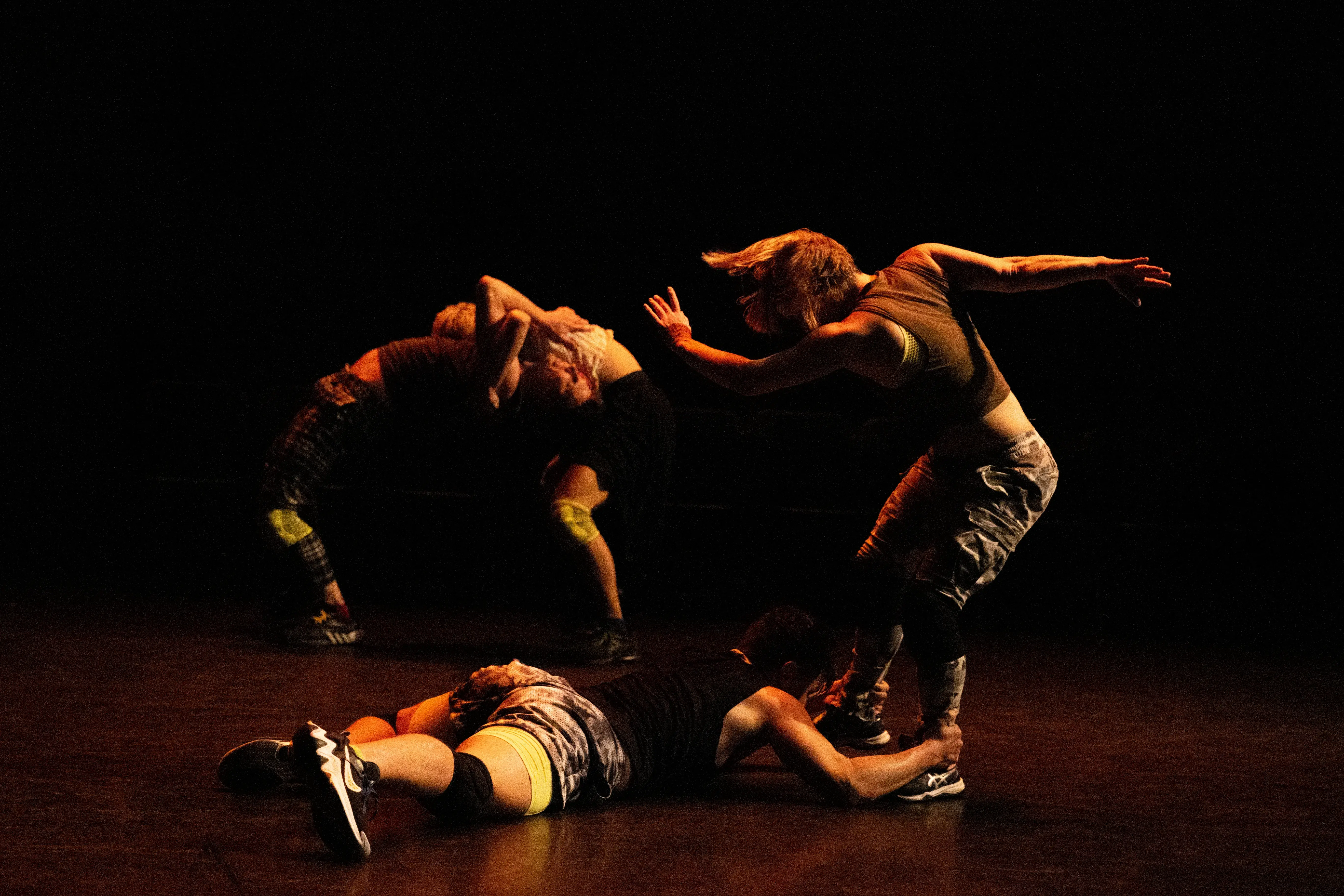 Dancers in movement, with one person on the floor