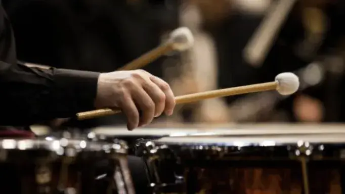 Person playing the drums.