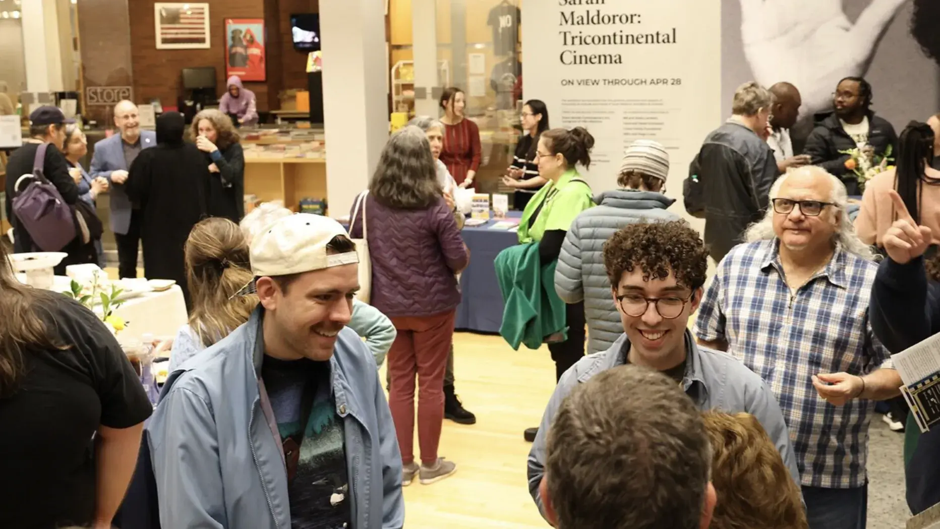 Cinema Revival 2024 attendees mingle around food and drink in the Wexner Center lower lobby.     