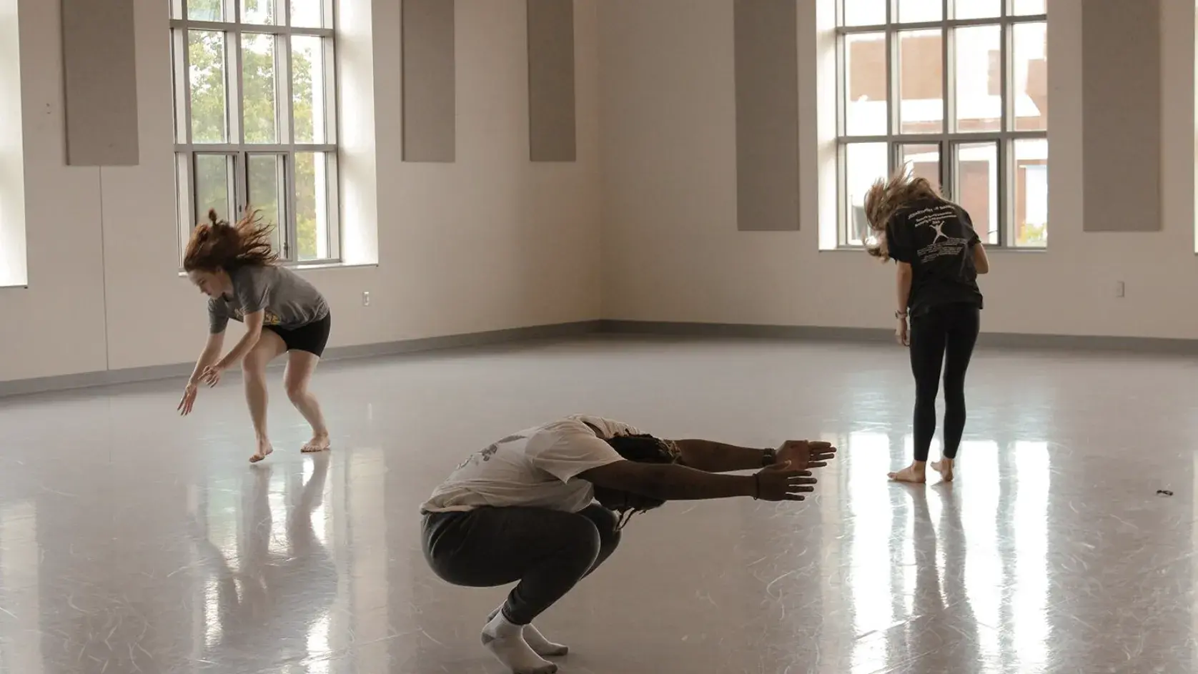 Three Ohio State dancing Students rehearsing a dance. 