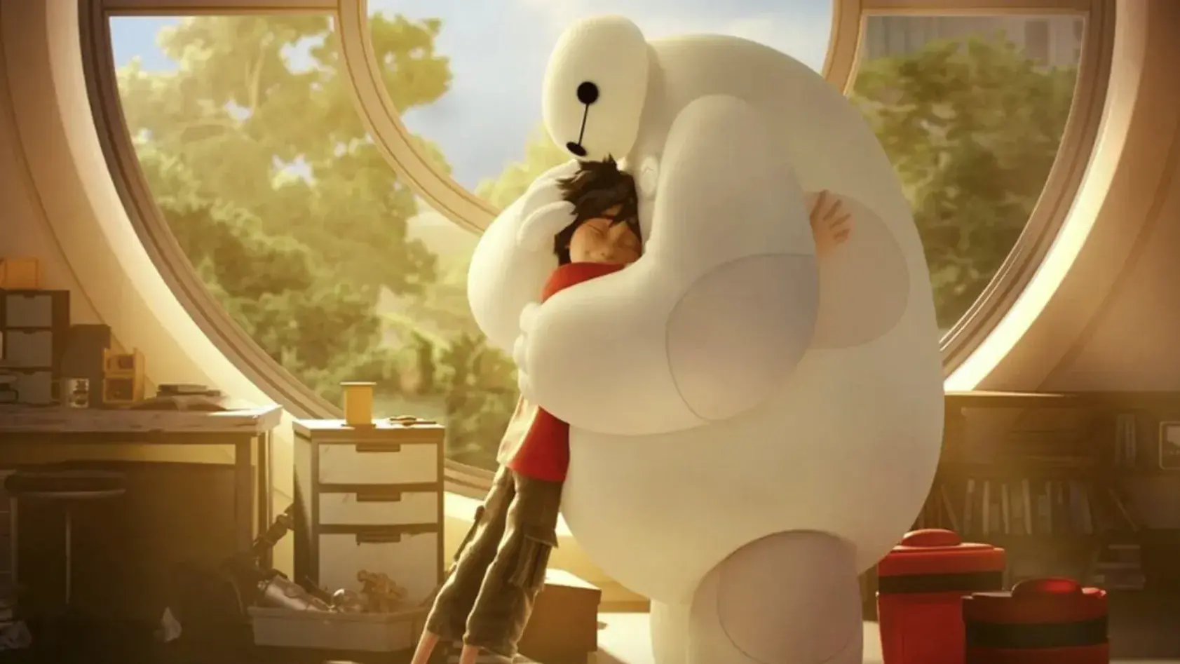 Animated still of a large white inflated robot hugging a thin boy in front of a large circular window.