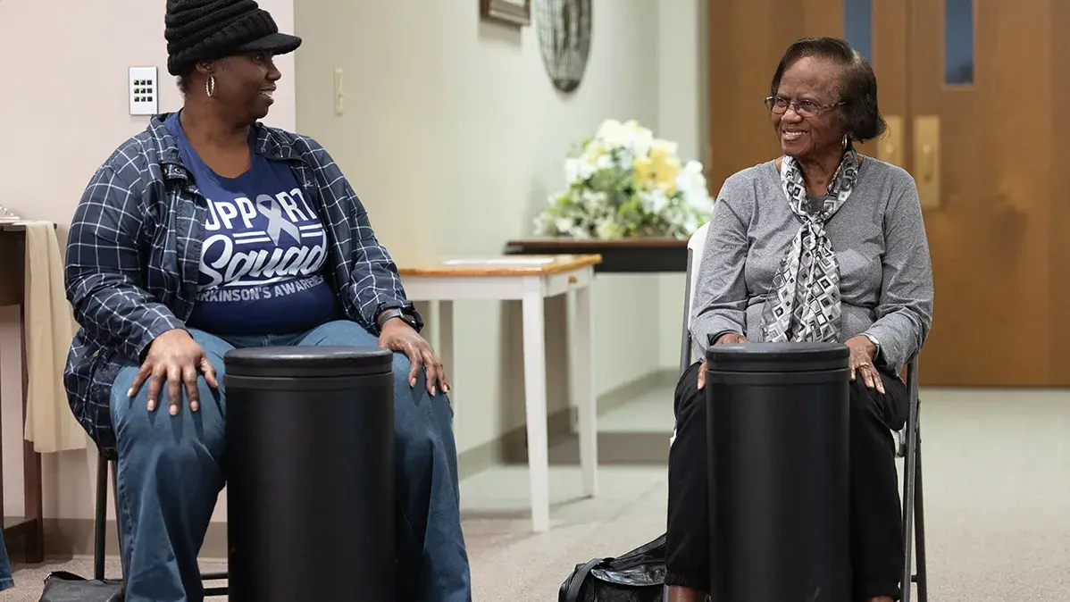 Ruthie Clemons (right) and her daughter Yolanda smile at one another during a recent Drumming for Wellness class at Ohio State Lima.