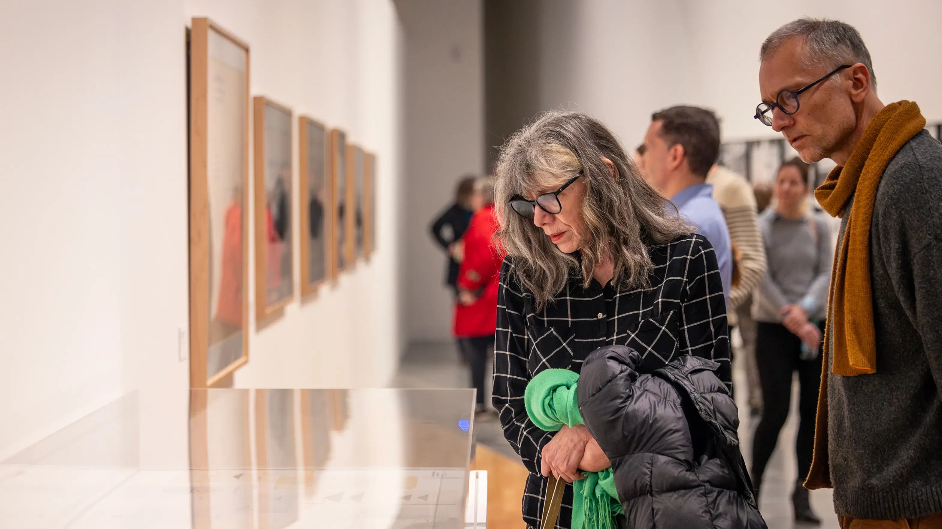 People look at art in a gallery