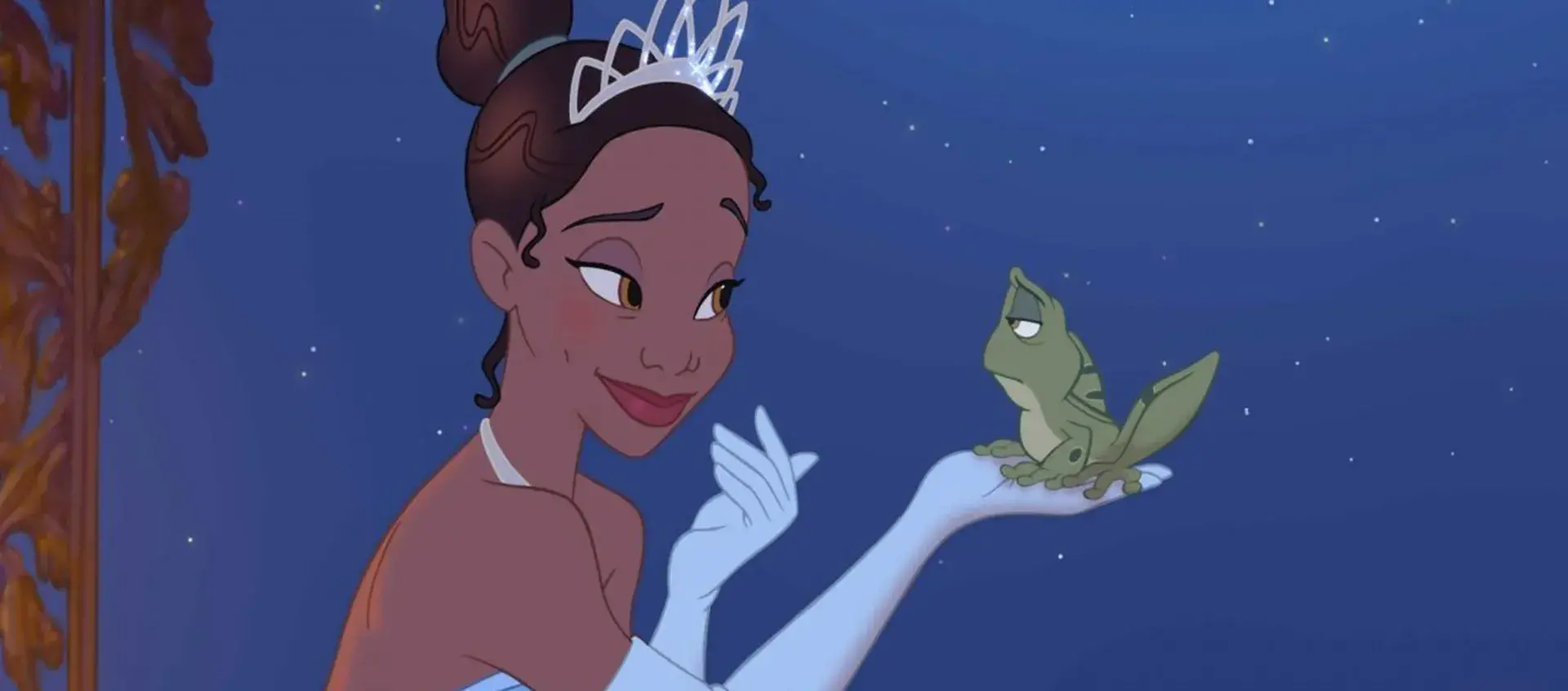An animated image of Tiana holding a frog and smiling at it. Tiana wears a tiara and gloves. The frog looks unamused.
