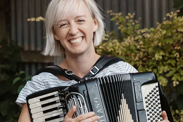 Chelsea Burns holding an accordion. 