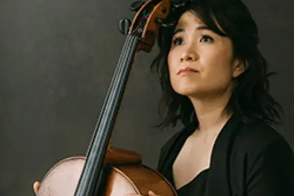 Julia Yang posing with a cello.