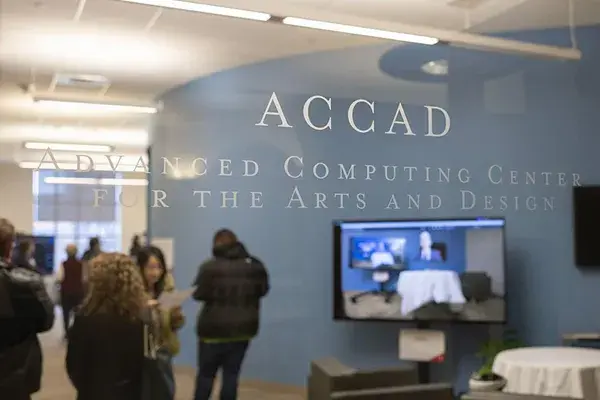 Image of the ACCAD space with a people standing near a monitor