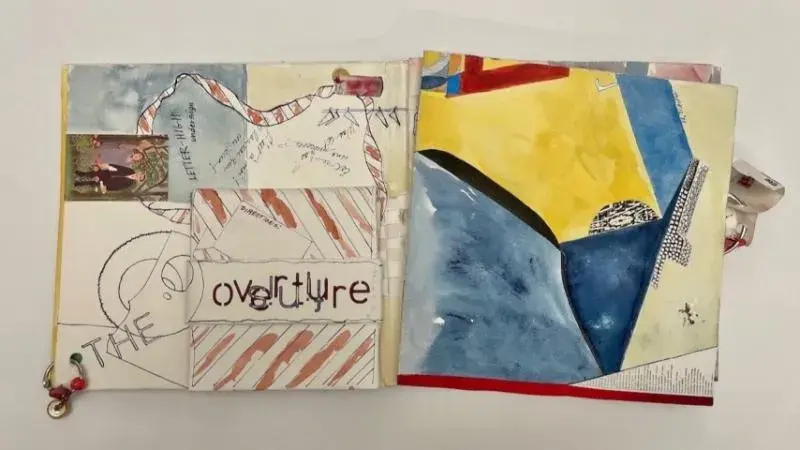 Artwork that looks like an open book with colored drawings on the pages