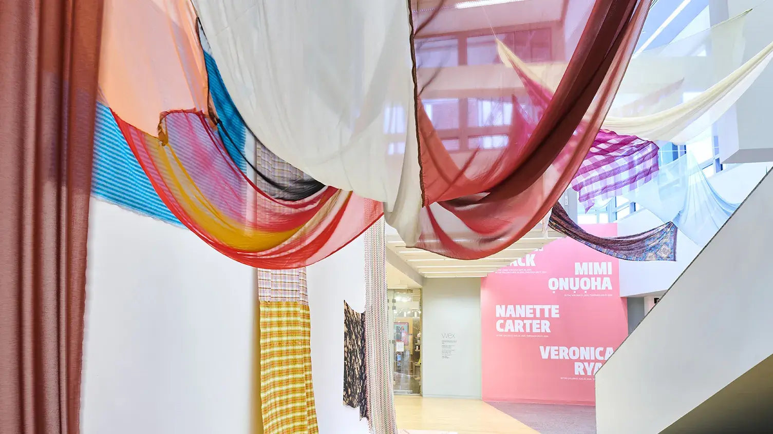 Panels of sheer, colored fabric hang in the Wexner Center lobby space