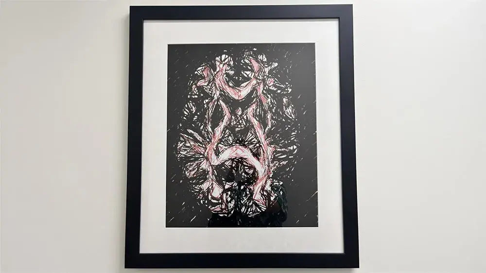 Framed brain scan image in black, white, and pale pink