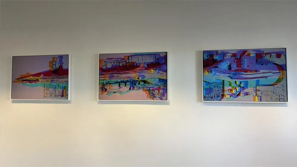 Three brightly colored artworks on a wall