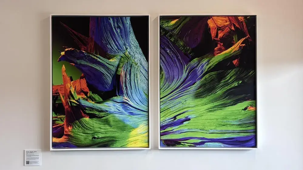 Two brightly colored artworks on a wall