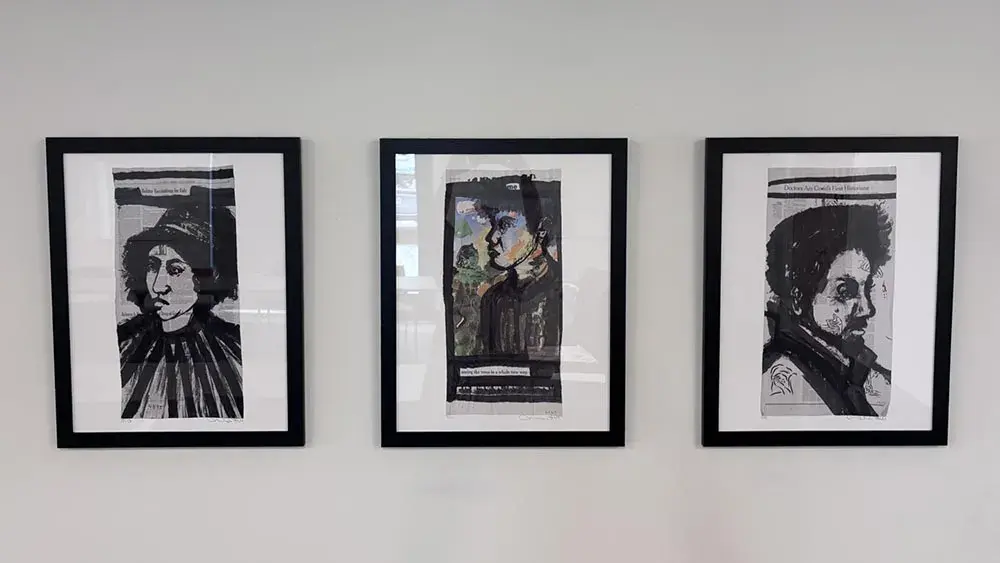 Three framed artworks on a wall