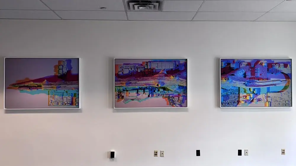 Three brightly colored artworks on a wall
