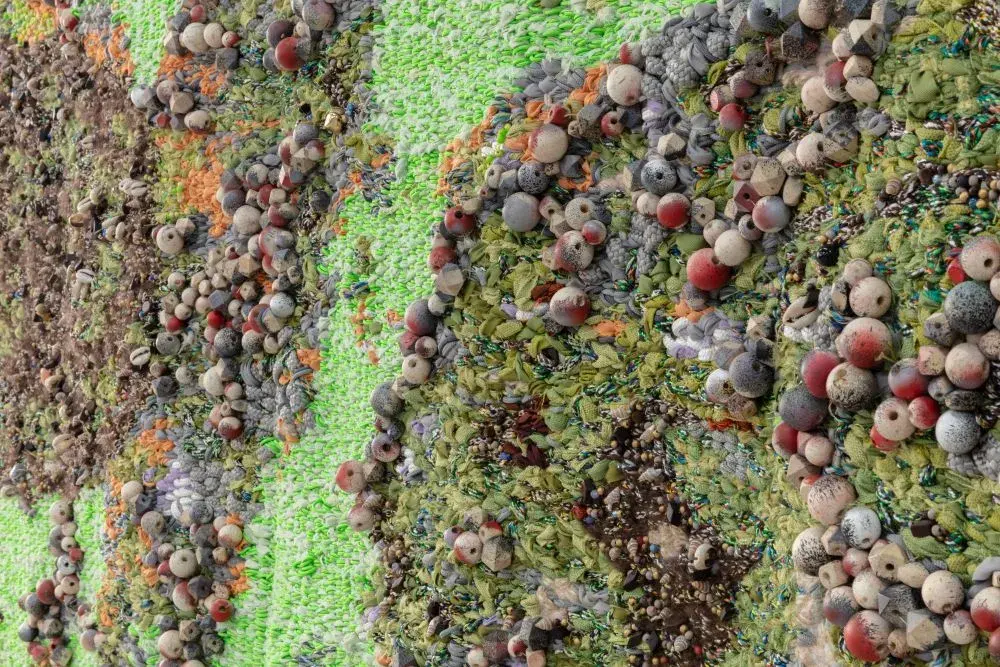 Close-up detail of artwork made of fibers and beads
