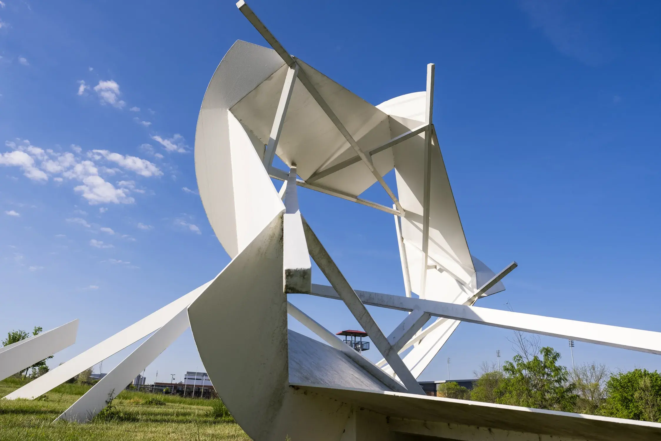 An abstract white sculpture in front of a bright blue sky