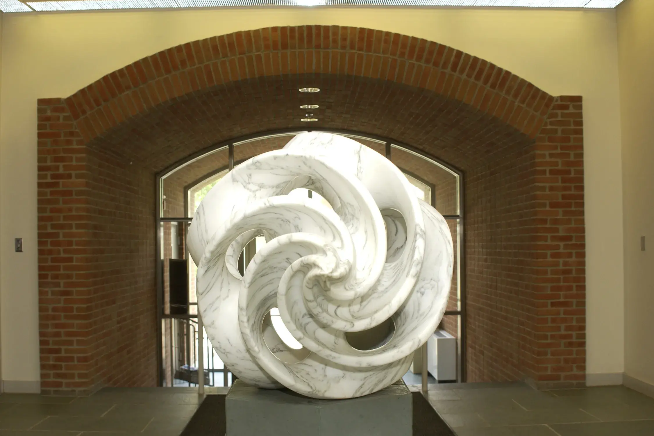 Sculpture made of swirling pieces of white and gray marble