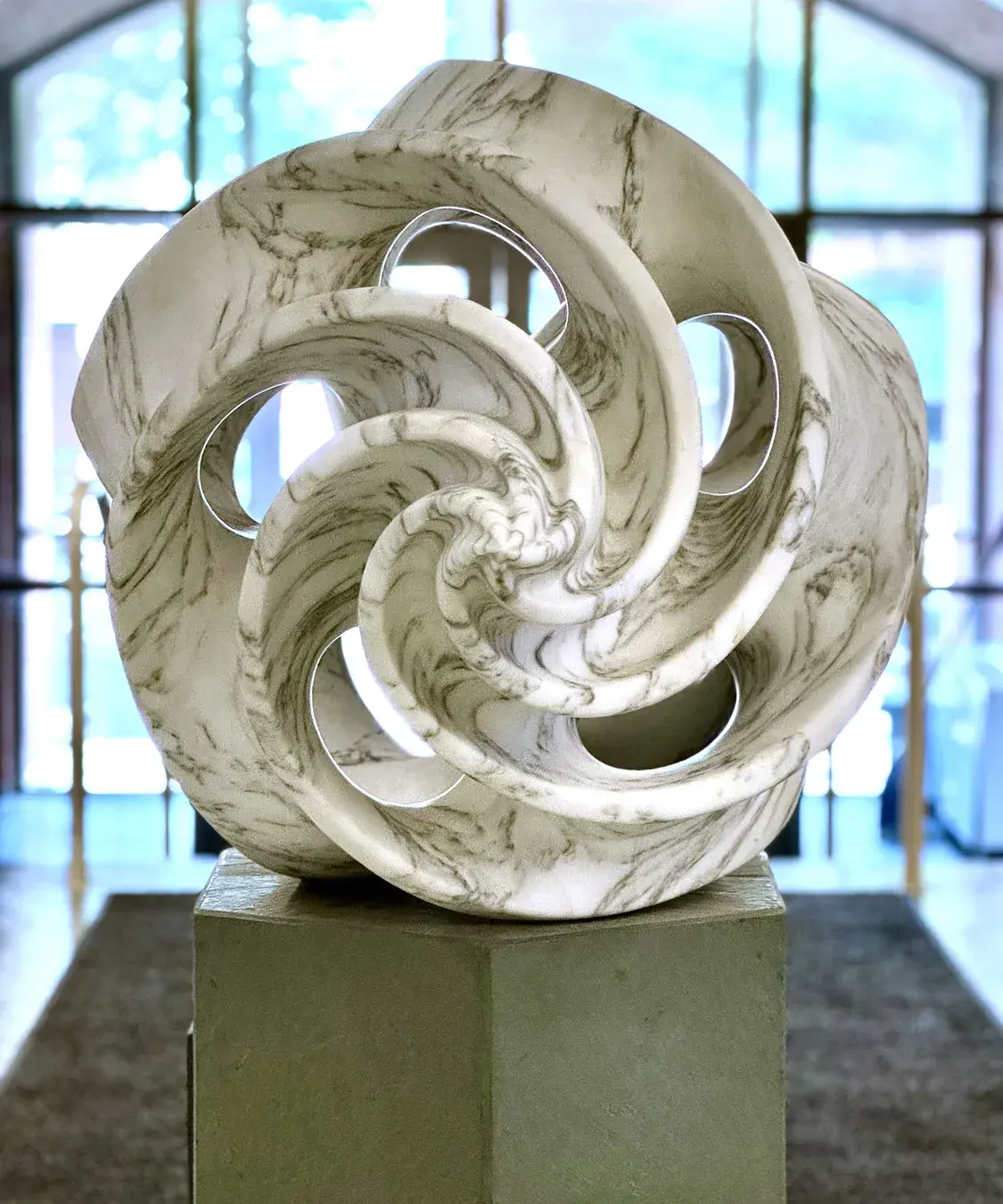 Sculpture made of swirling pieces of white and gray marble