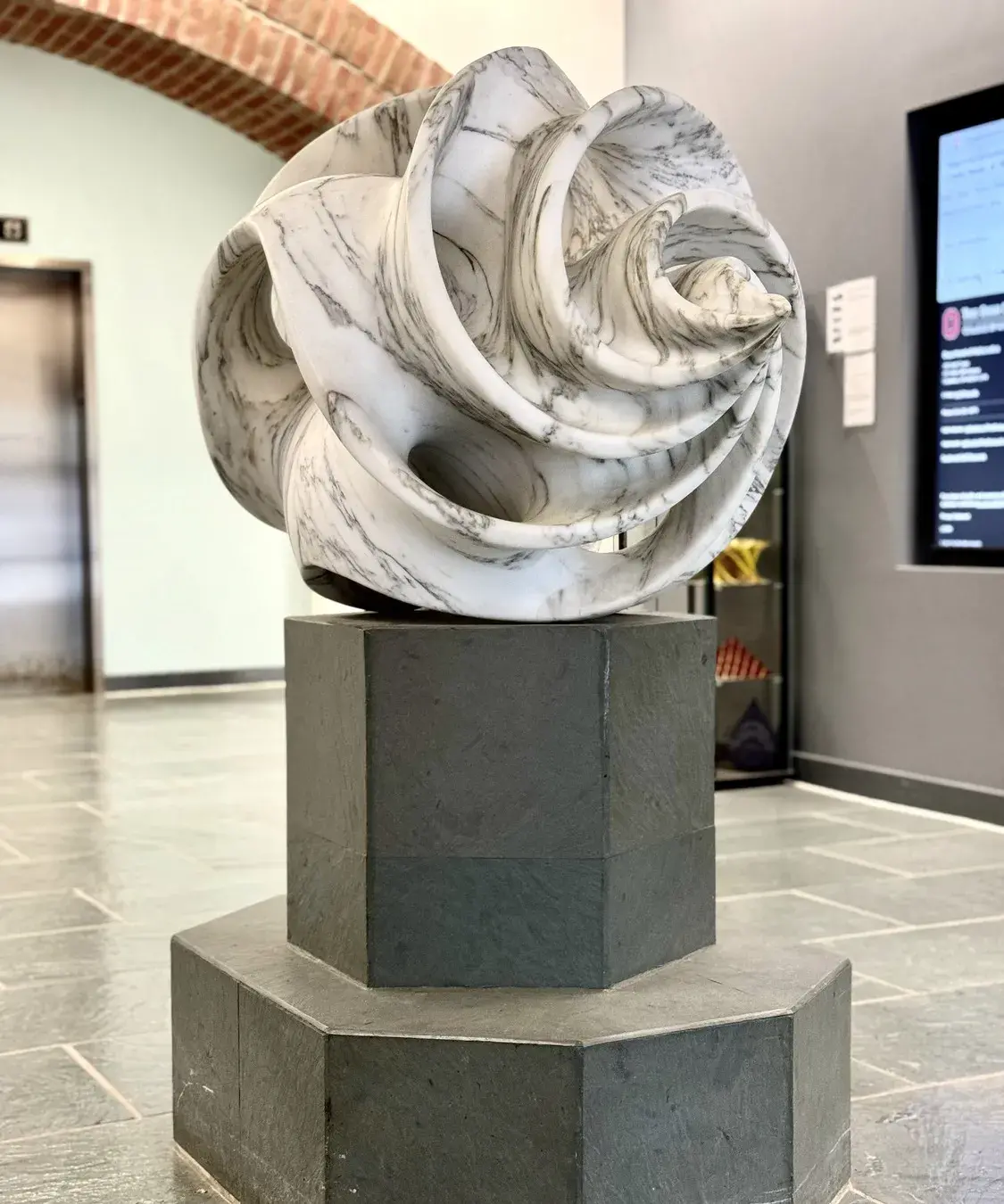 Sculpture made of swirling pieces of white and gray marble