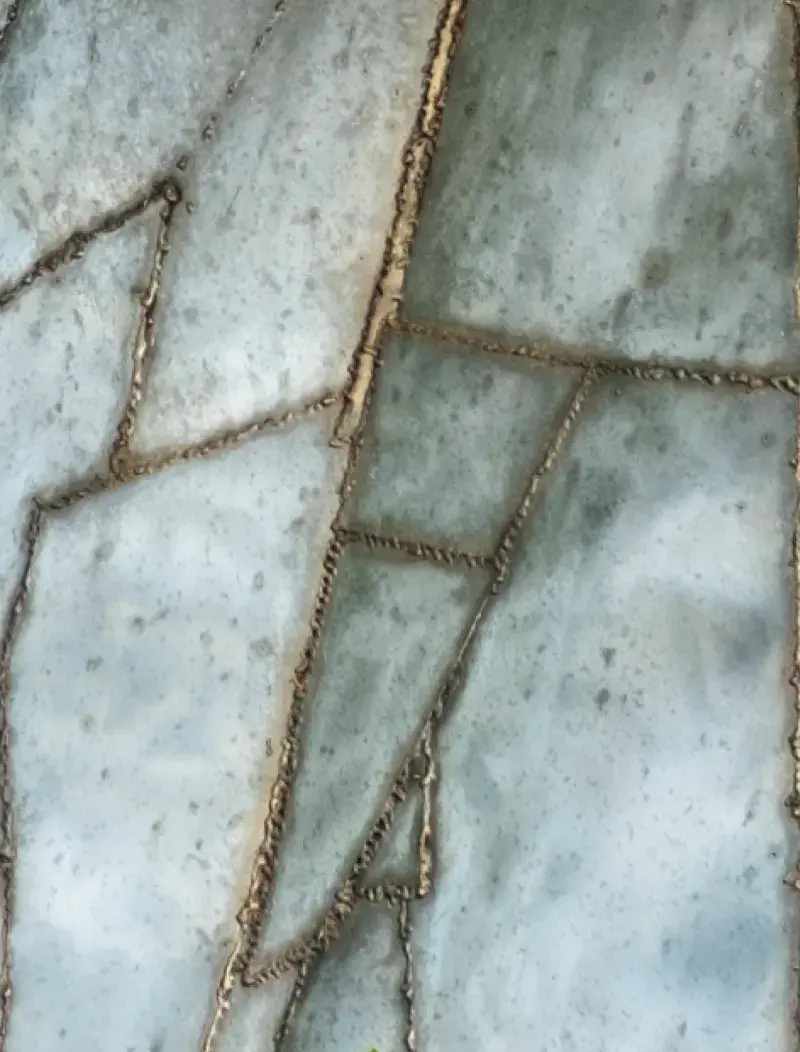 Close up of a metal sculpture showing the details of it&#039;s cracked surface.